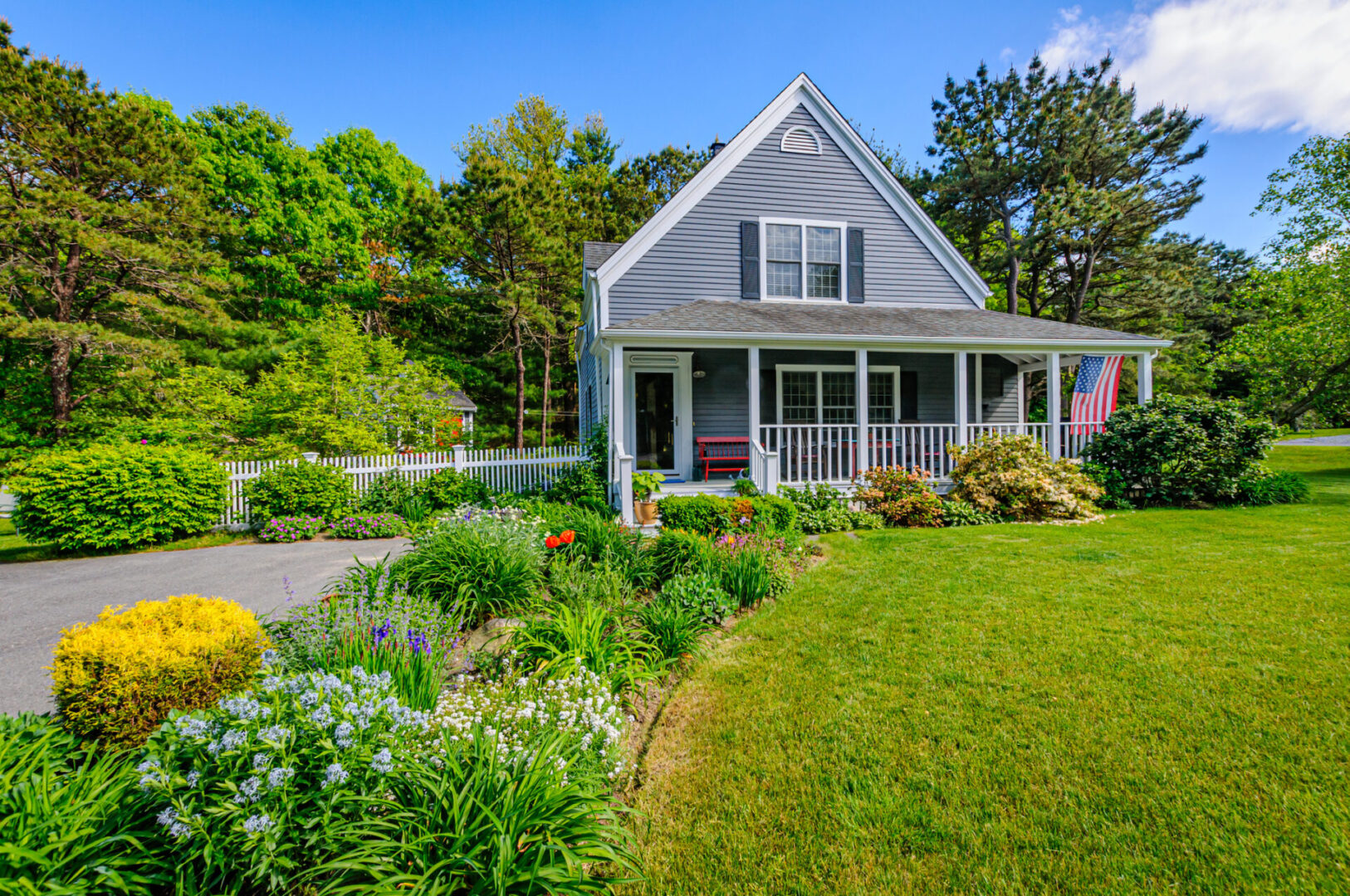 Charming house with garden and white fence.