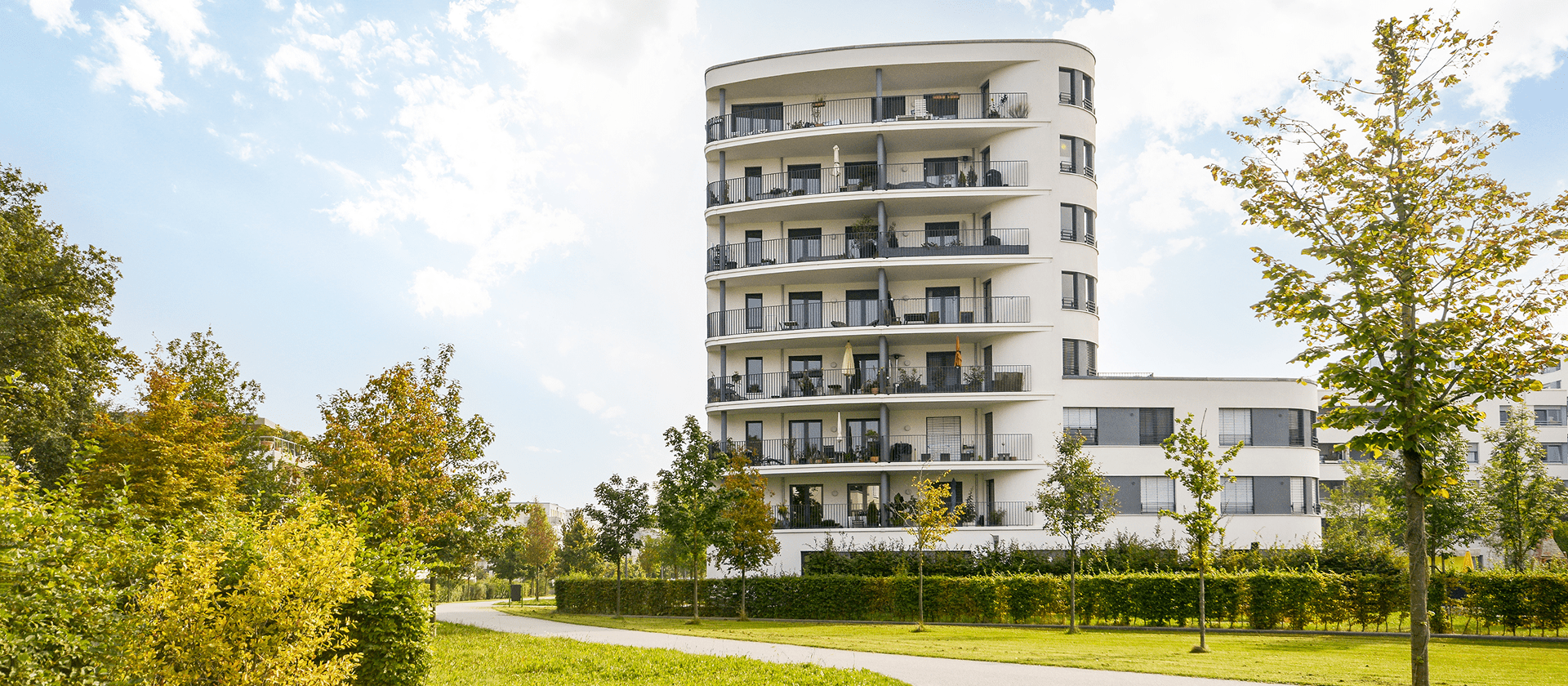 Modern apartment building with surrounding greenery.