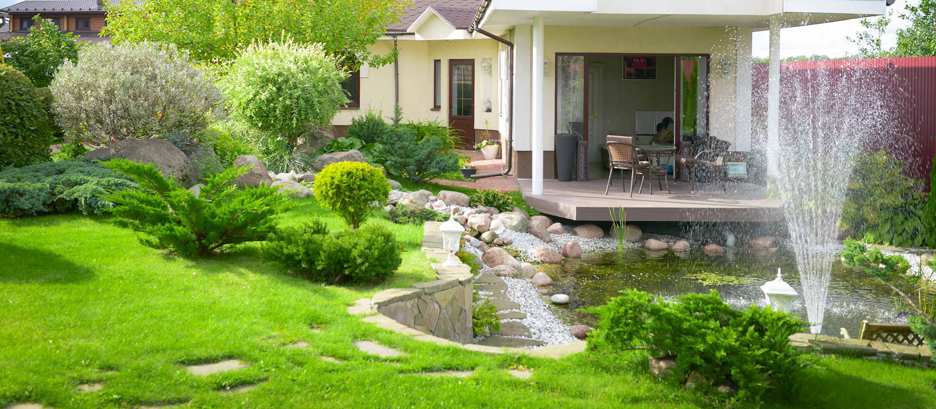 Garden with fountain and patio area.