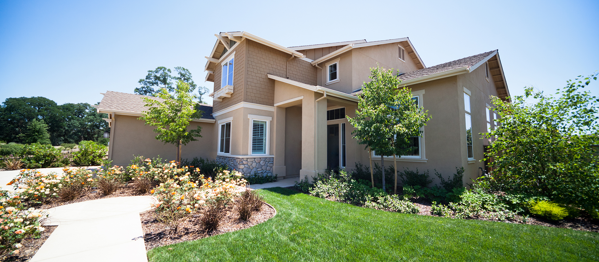 Modern two-story house with landscaped yard.