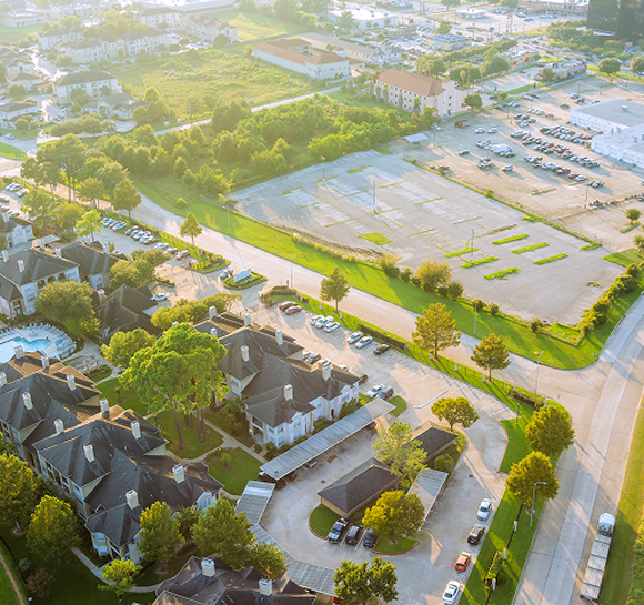 Aerial view of suburban neighborhood and parking lot.