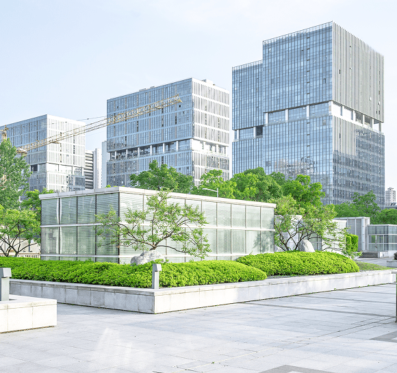 Modern buildings with greenery and trees.